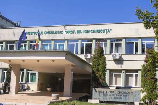 Entrance to the Prof. Dr. Ion Chiricuta Oncology Institute with Romanian and European Union flags - Cluj-Napoca, Romania - August 16, 2026