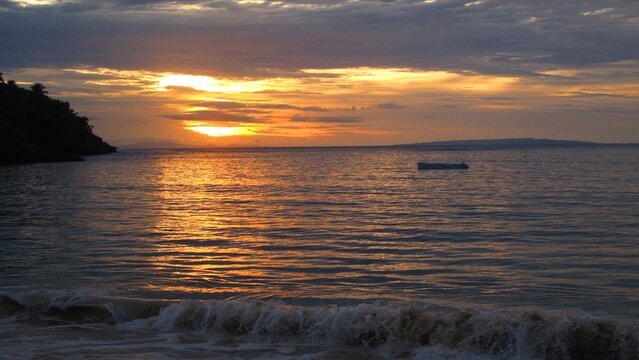 Golden sunset over a calm Dominican Republic bay