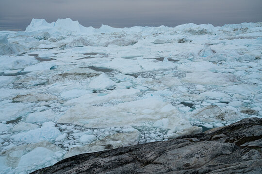 Global warming - Greenland Iceberg landscape of Ilulissat icefjord with giant icebergs. Icebergs from melting glacier. Arctic nature heavily affected by climate change.