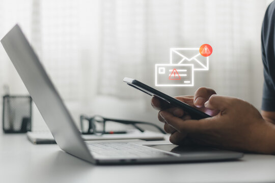 Fraud, sms spam, fake text message phishing from scammer concept. System hacked red warning alert, email hack, scam malware spreading virus on message alert virtual on smartphone screen in person hand