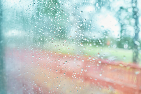 Raindrops on Window Glass With Blurred Colorful Background