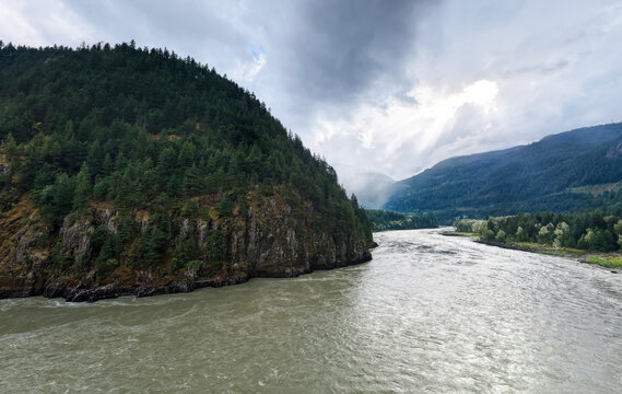 Fraser River Gorge With Pine-Covered Cliffs and Misty Mountains Near Hope, BC, Canada