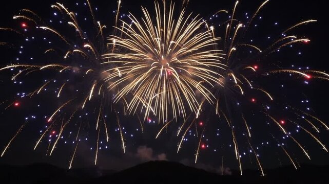 Colorful fireworks illuminating the dark night sky over hills