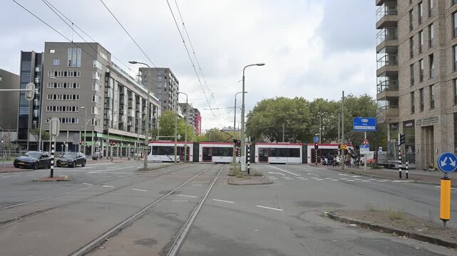 Tram running accros the car roads in the city