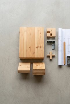 Wooden Building Blocks and Blueprint for Construction Project.
