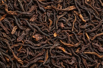 Fototapeta premium Macro texture of dry loose black tea leaves. Organic dark tea ingredients pile for beverage agriculture concept. Close up view shows natural herbal leaf pattern with rich detail. Dried tea background