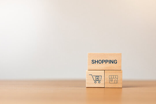 Wooden blocks with the text E-COMMERCE and an AI shopping cart icon; concept of an AI-automated online store, e-commerce, and digital transformation.