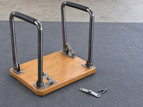 Upside down folding stool with replacement folding stay and two screws on repair mat