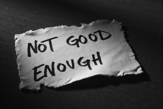 Torn Paper with Not Good Enough Message Symbolizing Self Criticism and Low Self Esteem