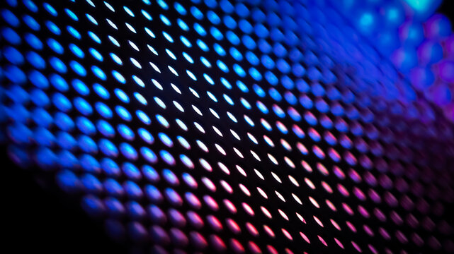 Abstract pattern glows with vibrant hues against a dark backgrou