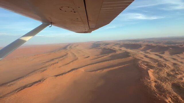 View from the plane over endless sand dunes of the Namib Desert, impressive desert landscape, sightseeing flight in the evening light, aerial view, Namib-Naukluft National Park, Namibia