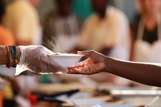 Charity volunteer providing food assistance to support a person in need at a community kitchen