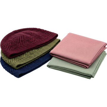 Stack of knitted kufi prayer caps in burgundy, olive and navy with two folded plain scarves in dusty rose and sage green