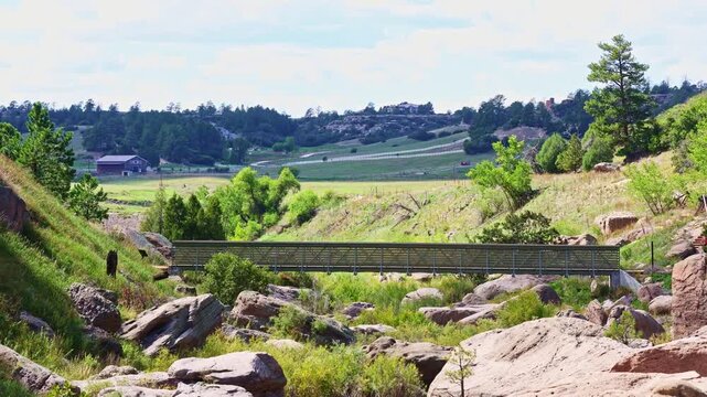 Rugged canyon rim and lush prairie creek valley stretch toward distant horizons at Castlewood Canyon State Park Colorado