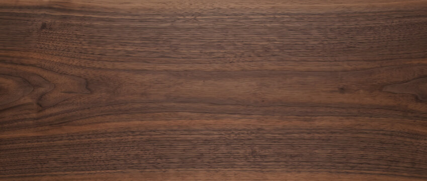 Dark walnut wood texture with smooth chocolate grain and natural knot detail creates a warm luxurious background for design