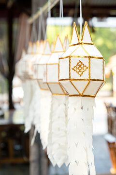 Traditional Lanna white paper lanterns hanging at Wat Ton Kwen temple in Chiang Mai, Thailand. Asian cultural background.