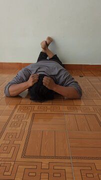 Young Man Suffering Depression Attack Holding His Head in Despair