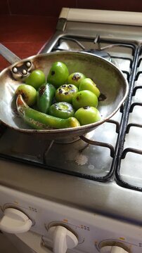 Stirring Roasting Tomatoes and Chili Peppers in Hot Pan