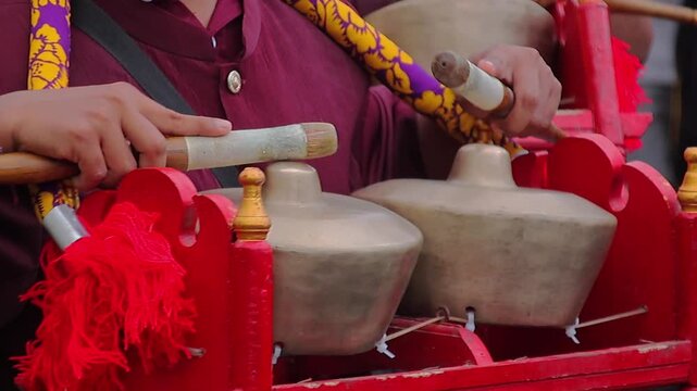 Traditional Sasak Musician Playing Gendang Beleq Bronze Instrument in Lombok