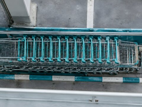 Nested stack of shopping carts in a return bay on an upper parking deck of a modern megamall