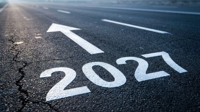 Conceptual road with the number 2027 painted on the asphalt with an arrow pointing forward, representing the future, goals, and planning for the year