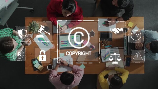 A business team collaborates around a table filled with charts and copyright symbols, highlighting the importance of intellectual property in modern projects. Raster