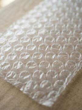 Clear transparent air bubble cushioning material on wooden surface