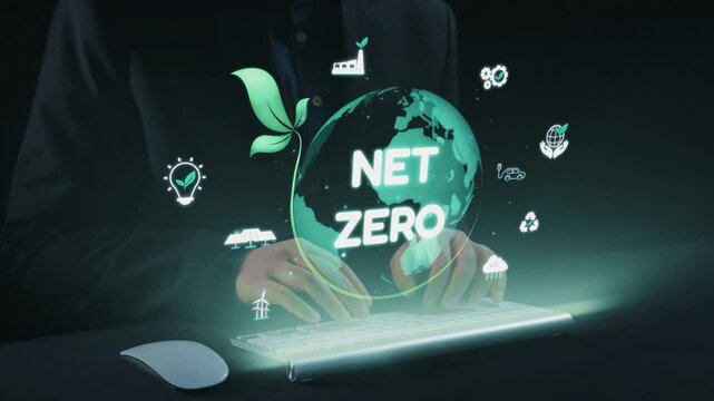 A person is typing on a keyboard, surrounded by luminous green graphics that symbolize net zero and sustainability, highlighting the importance of eco-friendly practices. Qubit
