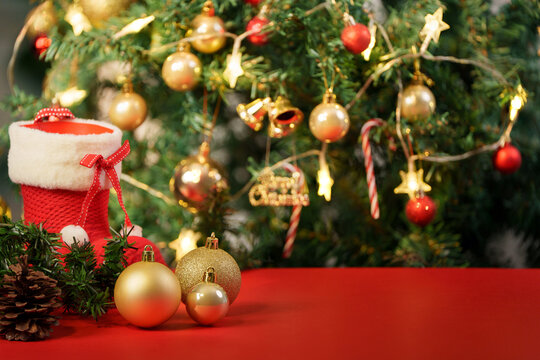 Christmas background with golden ornaments, stocking, and illuminated tree