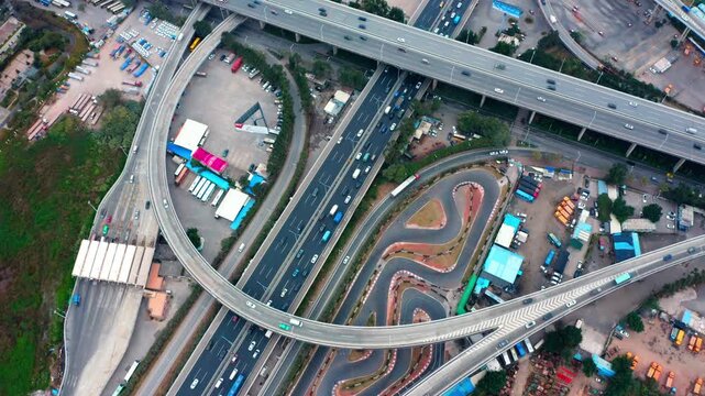Aerial View of Highway Interchange and Curvy Test Track with Traffic