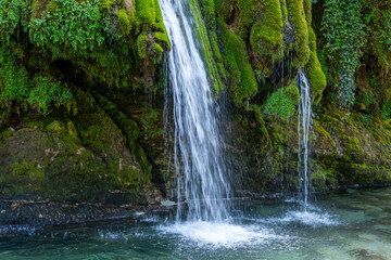 Kaghu Waterfall, located in the Samegrelo region of Georgia, A vibrant waterfall cascades down a mossy stone © k_samurkas