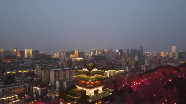 Illuminated Traditional Chinese Pavilion Overlooking Modern City Skyline at Dusk in Xi an, China