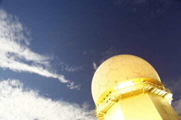 Fototapeta premium Radar dome glowing under starry night sky.