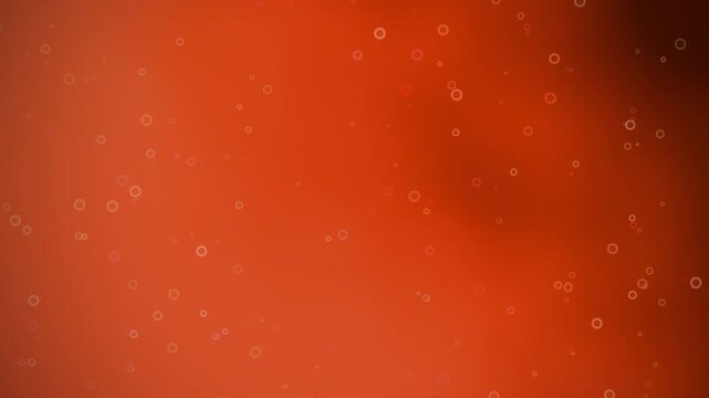 Abstract background featuring numerous small, light-colored bubbles rising against a gradient of orange hues.