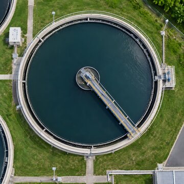 Wastewater treatment plant clarifier tank aerial view showing circular industrial basin and filtration infrastructure