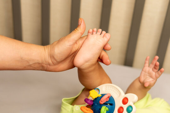 Mother Holding Baby Foot During Gentle Infant Care
