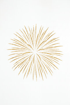 Gold starburst ornament on white background with copy space