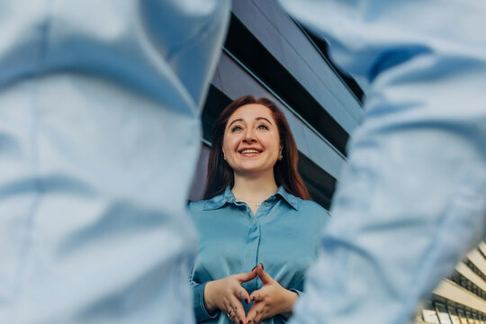 Female manager or employee talking with business colleague, stylish suit, outdoor portrait