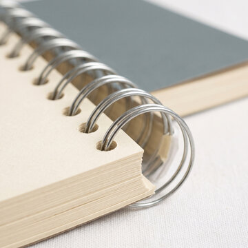 Spiral-bound notebook with wire binding and blank pages  