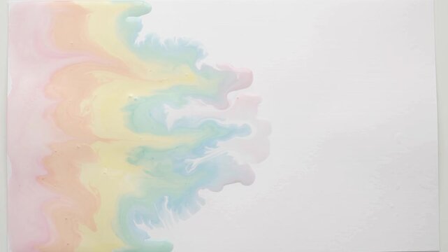Pastel rainbow watercolor wash spreading across wet paper
