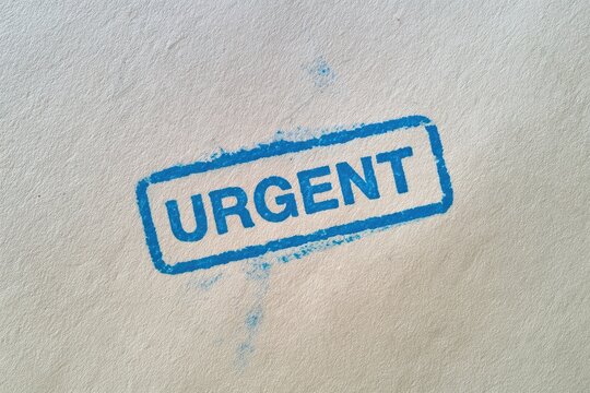 Blue urgent stamp impression signifying a deadline or high priority