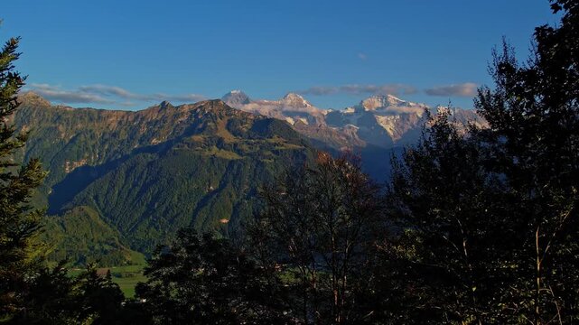 Aerial view of Harder Kulm viewpoint above Interlaken at autumn sunset, Switzerland, with turquoise Lake Thun and Lake Brienz.