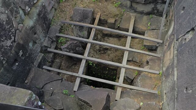 Zoom-out reveals a stone opening inside the summit platform shrine atop Koh Ker Pyramid Temple in Preah Vihear, Cambodia