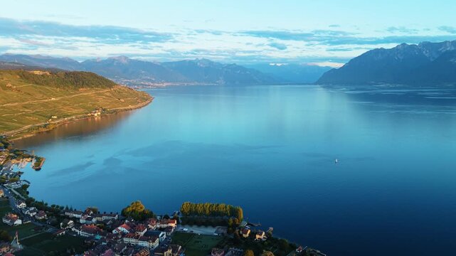 Drone flies forward toward Lake Geneva near Cully, Switzerland, mountains beyond