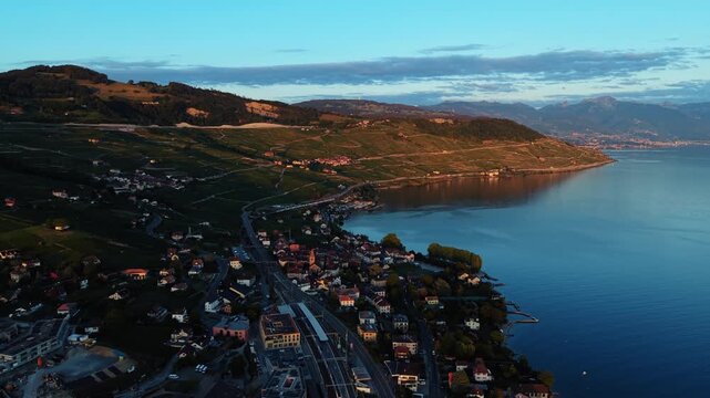Drone flies along the coastal road by Lake Geneva near Cully, Switzerland