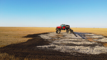 Aerial View of Self-Propelled Agricultural Sprayer Treating Stubble Field © Andrey