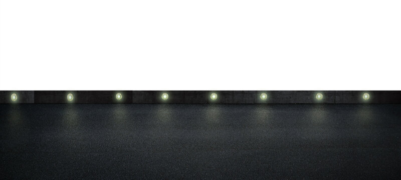 Empty dark asphalt road with illuminated wall lights at night