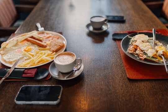 Enjoying breakfast with coffee at a restaurant table