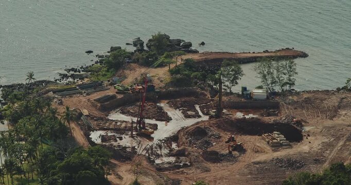 coastal land and earthworks on a small tropical island. Coastal Construction Site on Tropical Island.