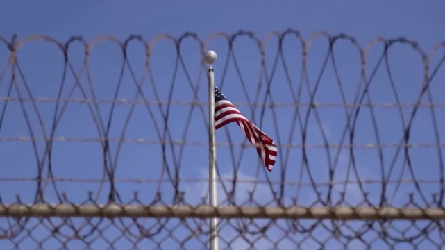 American Flag Behind Barbed Wire Fence